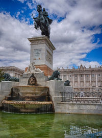 Low angle view of statue against cloudy sky