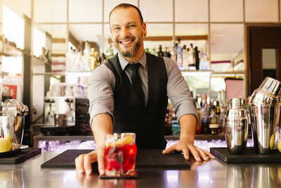 Smiling bartender at bar