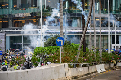 Group of people on road against buildings