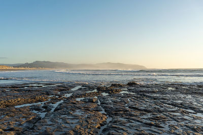 Scenic view of sea against clear sky during sunset