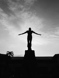 Low angle view of statue against cloudy sky