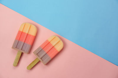 High angle view of candies on table against blue background