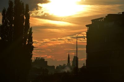 Buildings in city at sunset