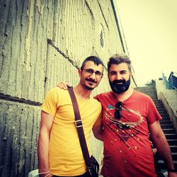 Portrait of smiling young couple standing outdoors