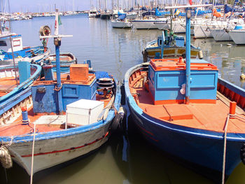 Fishing boats moored at harbor