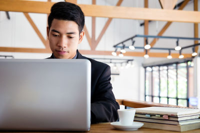 Young businessman working with laptop.