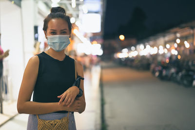 Cinematic style , young woman touring in night market , standing on footpath, chiang mai thailand