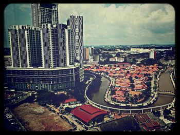 Cityscape against cloudy sky