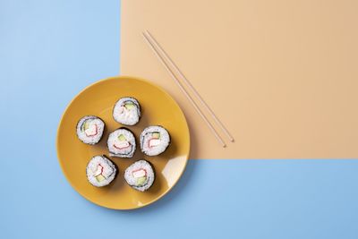 Directly above shot of sushi on colorful table