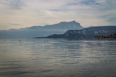 Scenic view of sea and mountains against sky