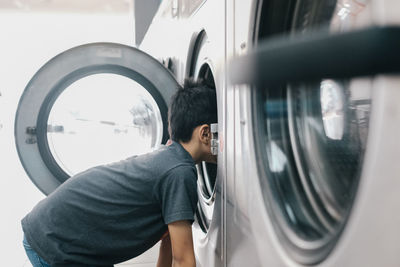 Boy looking into washing machine