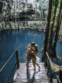 A couple enjoys the time at a cenote in mexico. 