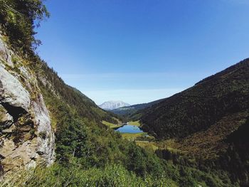 Scenic view of mountains against clear blue sky