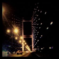 Low angle view of illuminated street lights at night