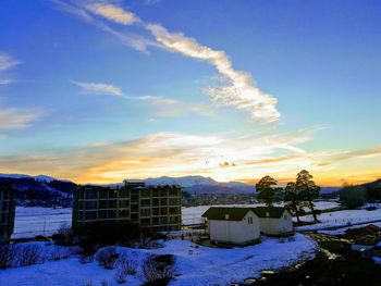 Built structure on field against blue sky during sunset