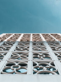 View looking up to the blue sky up building with pattern architecture 