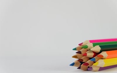 Close-up of multi colored pencils against white background