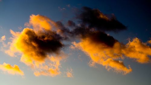 Low angle view of cloudy sky at sunset