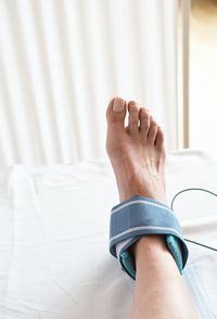 Low section of woman lying on bed