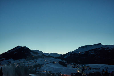 Scenic view of snowcapped mountains against clear blue sky