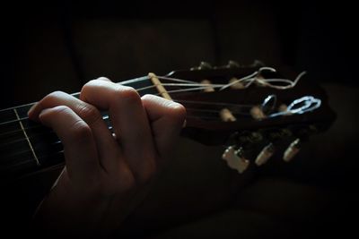 Cropped hand playing guitar