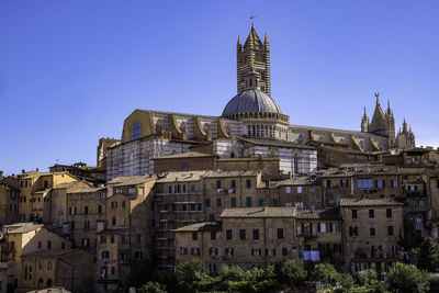 Panoramic view of siena with tiled rooftops, duomo and torre del mangia - tuscany, italy