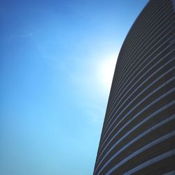 Low angle view of cropped built structure against clear blue sky