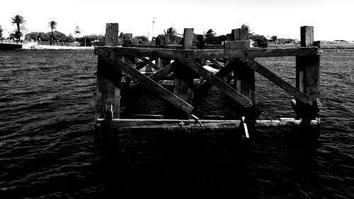 Pier over sea against clear sky