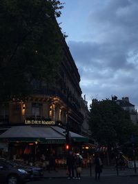 People on street in city against sky