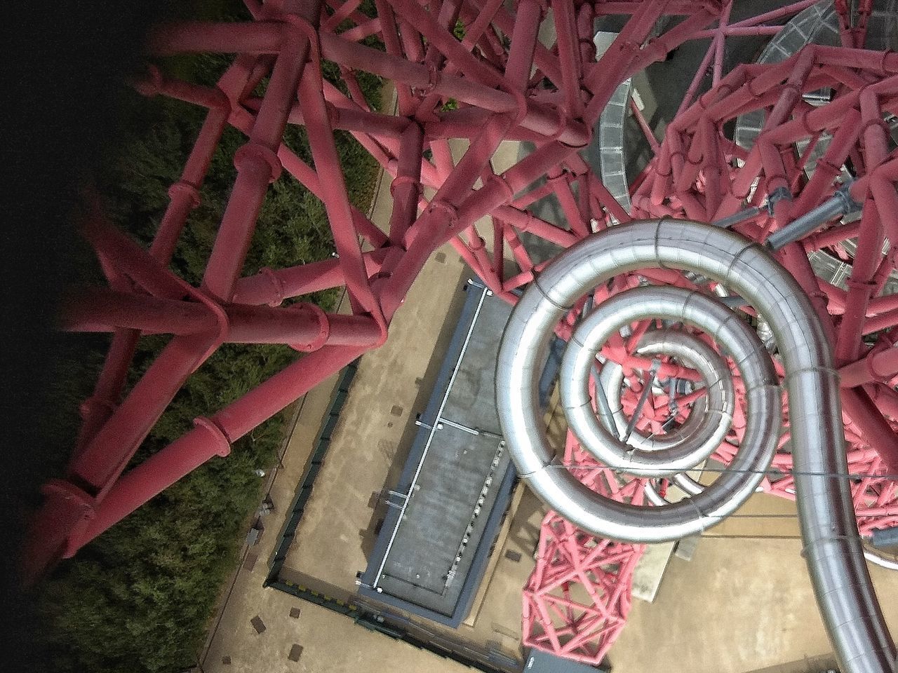 HIGH ANGLE VIEW OF SPIRAL STAIRCASE ON RED RAILING