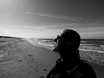 Friends at beach against sky