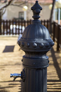 Close-up of railing on footpath