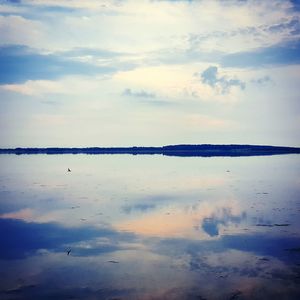 Scenic view of sea against cloudy sky