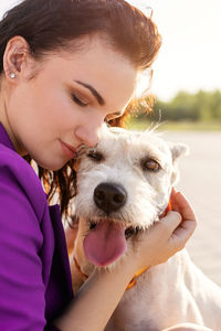 Portrait of woman holding dog