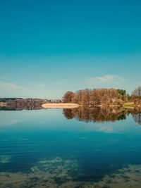 Scenic view of lake against blue sky