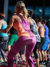 Rear view of woman dancing against blurred background