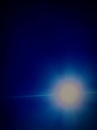 Defocused image of blue sky against bright sun