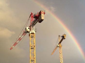 Low angle view of crane against sky