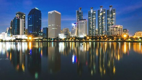 Reflection of illuminated buildings in city at night