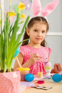 Portrait of cute girl playing with toys on table