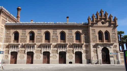 Facade of historic building against clear blue sky