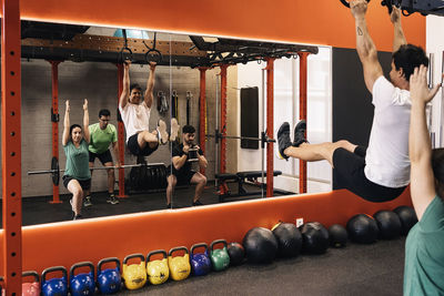 Group of beginners athletes exercising in a personal class with a private trainer. various exercises