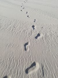 High angle view of footprints on sand