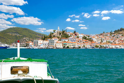 Scenic view of sea by town against sky