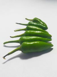 Close-up of green chili pepper on white background