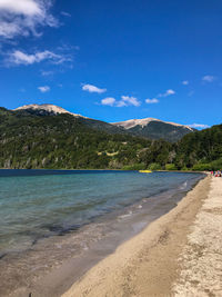 Scenic view of beach against blue sky