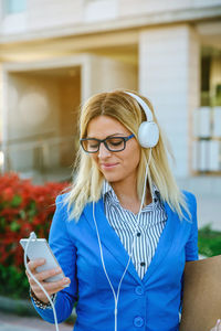 Young woman using smart phone outdoors