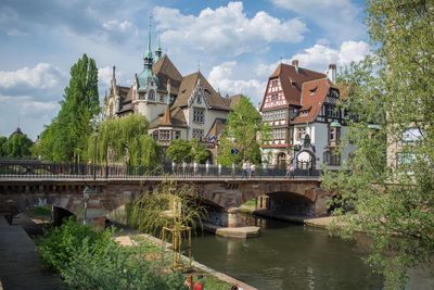 Bridge over river against buildings