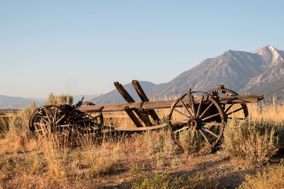 Abandoned truck on field against clear sky