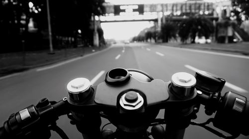 Cropped image of motorcycle on road